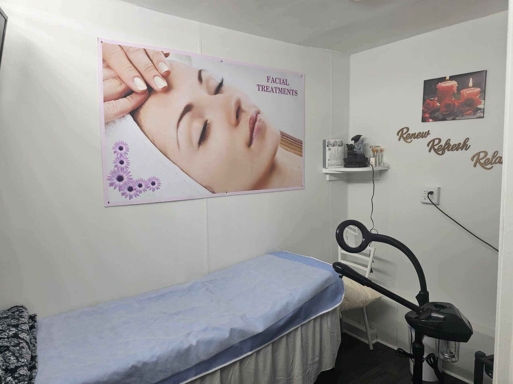 A private treatment room at Creative Brows with a clean bed and magnifying lamp